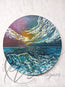 Original painting by Hannah Singleton owner and artist behind HLSdesigner. Based in Cornwall and taking inspiration from the ocean around her. This painting depicts a violet sunset in bold colours with a textured surface, over looking the calm ocean with a peak rising in the foreground of a lapping wave glistening the luminous spectrum of colours from the sun above, painted on a round canvas 