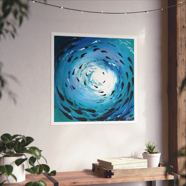 Unframed abstract artwork of a blue spiral wave under ocean of a fish shoal swimming on a white wall with plants and books below.