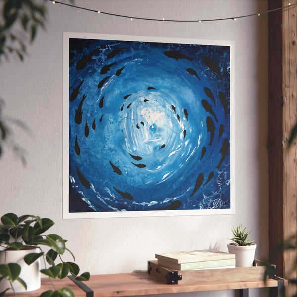 Artwork of a blue spiral vortex with black fish swimming under the sea with light shining through the ocean surface by hlsdesigner on a white wall above a wooden shelf.