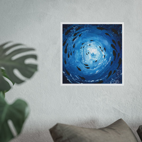 Unframed artwork of a blue spiral with black fish swimming in a shoal under the ocean surface on a white wall, next to a plant and a pillow. painted by HLSdesigner