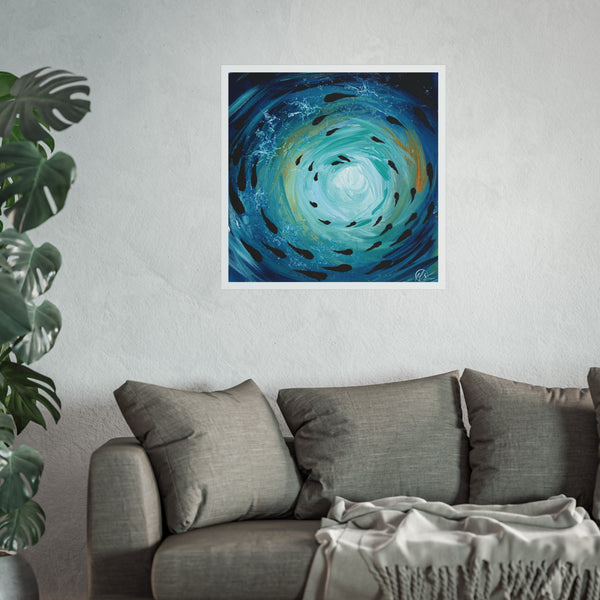 Abstract artwork of a blue spiral with black fish shoaling under the ocean surface and gold hues by hlsdesigner on a white wall above a grey sofa.