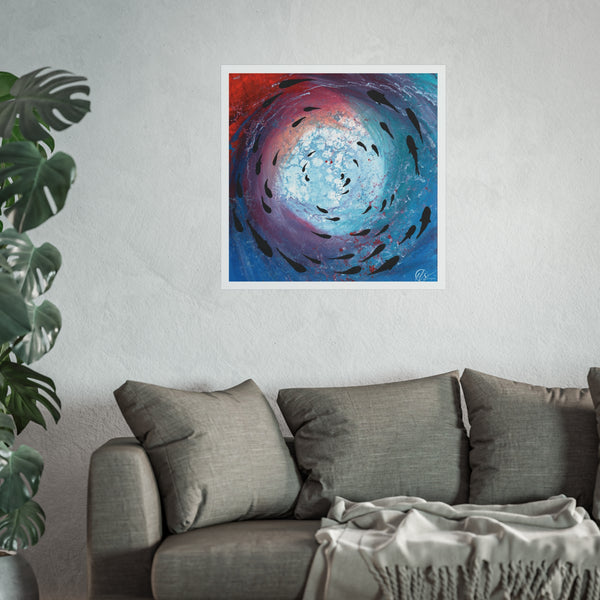 Abstract artwork of a swirling vortex and a fish shoal swimming below the ocean with red sunset hues displayed on a wall above a sofa with a plant to the left. Art print by Hlsdesigner 