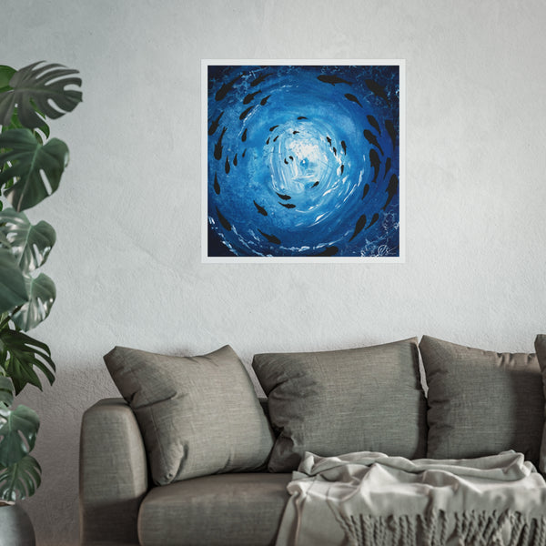 Blue abstract art print of a fish shoal under the ocean surface playing in the waves of a deep blue and indigo hue with white light shining through the sea by hlsdesigner on a wall above a grey sofa with a plant to the left.