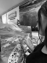 hannah singleton painting ocean artist cornwall. Painting a seascape of waves entering the shore. Black and white edit over the shoulder of Hannah’s viewpoint