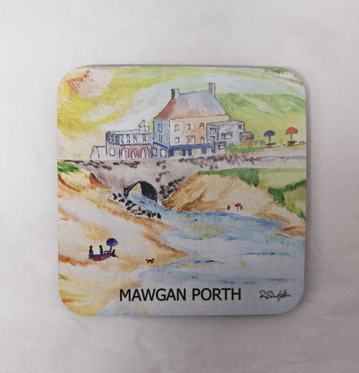 A square wooden coaster with a cork back and a high gloss finish featuring a print of Mawgan Porth beach in Cornwall - one of the watercolour paintings by R Singleton, reproduced by HLSdesigner in tribute. Image focuses on the contemporary sketch of the Merrymoor inn pub and the bridge that the stream flows under back into the ocean from the beach. 