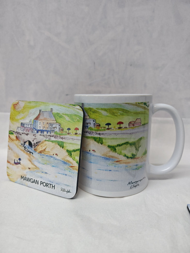 A white ceramic mug and matching square coaster printed with a watercolor landscape of Mawgan Porth, shown on a light gray textured background.
