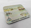A square coaster with rounded corners featuring a watercolor painting of fishing boats in Newquay Harbour, with the text 'NEWQUAY HARBOUR' printed along the bottom edge. Painted by R Singleton and printed exclusively by HLSdesigner