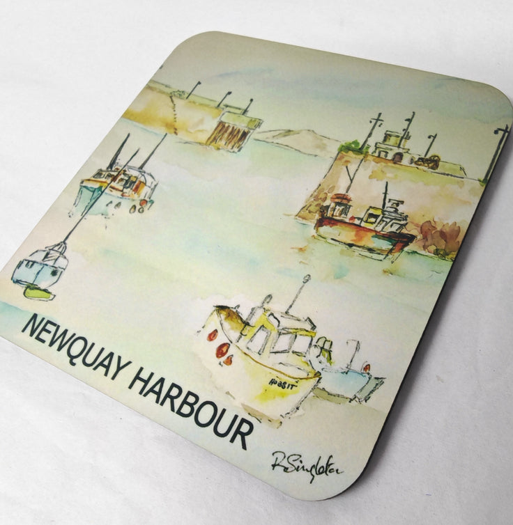 A coaster with rounded corners featuring a watercolour painting of boats in Newquay Harbour. The artwork shows several fishing boats on a light greenish-blue waterway with a sandy shore in the background. Cornwall gifts and souvenirs showing Cornish scenes and coastal paintings by artist R Singleton and HLSdesigner in Newquay cornwall