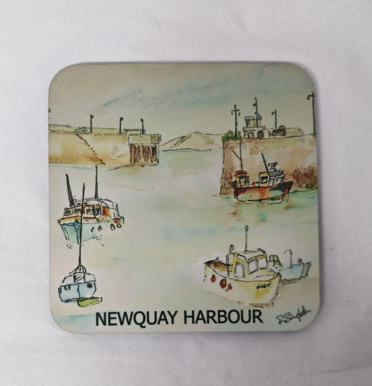 A square coaster with rounded corners featuring a watercolour painting printed of Newquay Harbour in Cornwall on a white background 