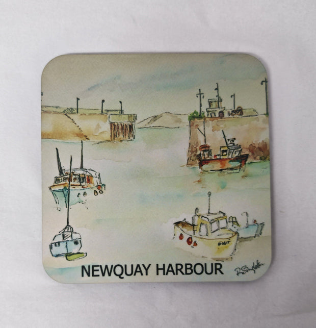 A square coaster with rounded corners featuring a watercolour painting printed of Newquay Harbour in Cornwall on a white background 