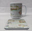 A white ceramic mug and matching rectangular coaster featuring a watercolour illustration of Newquay Harbour with boats and the text 'Newquay Harbour' and 'NEWQUAY HARBOUR'. HLSdesigner