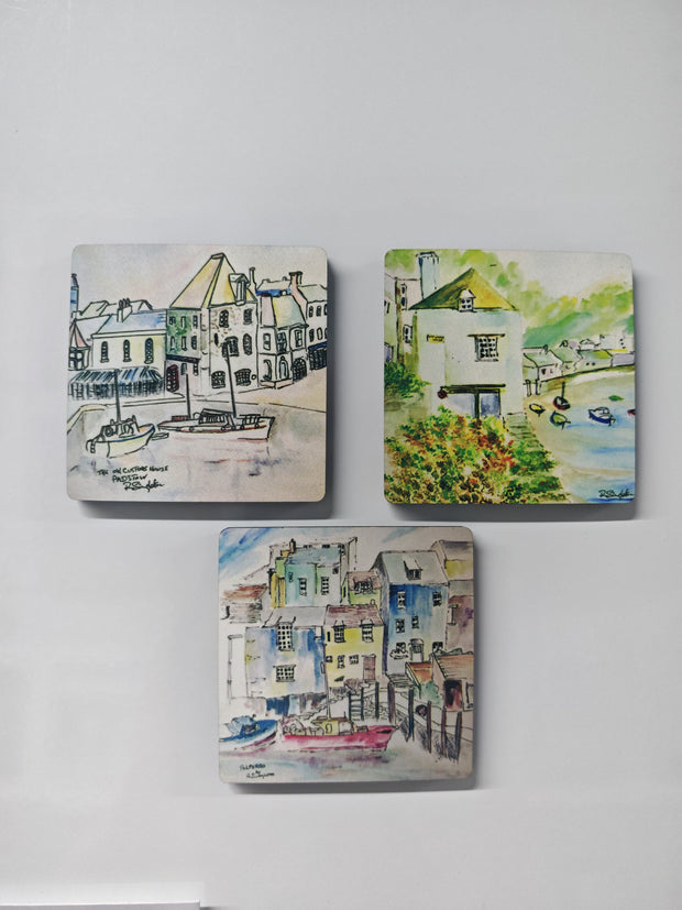 three square magnets attached to a white fridge background featuring the old watch house in Polperro Cornwall, the boats in the harbour and the old customs house in Padstow - watercolour paintings by R Singleton Cornwall based artist and reproduced as tribute by HLSdesigner in Cornwall 