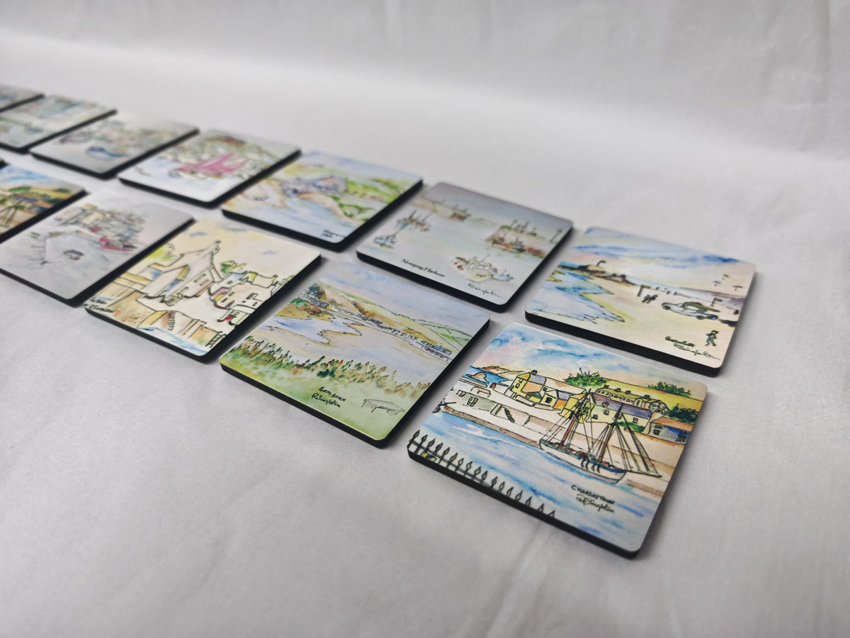 A set of illustrated magnets, watercolour print of R Singleton coastal cornwall paintings of various townscapes and beaches around cornwall. Collectable magnets lay together on a white background. Featuring perranporth, Charlestown, Porth beach, Polperro, Newquay, padstow and more. Designed and painted by R Singleton and reproduced into magnets by HLSdesigner in Cornwall, printed on wooden magnets with a high gloss finish