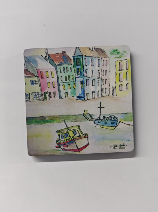 Wooden square fridge magnet with rounded corners and high gloss coating, featuring an artist depiction of St. Ives in Cornwall with watercolour fishing boats and illustrated linear housing in the background. showing the shopping strip with the boats moored to the beach wall. painted by R Singleton and reproduced into magnets exclusively by HLSdesigner 