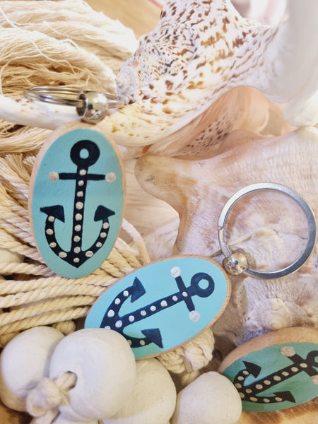 Keychain with anchor design on a background of seashells and rope