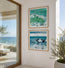 Two framed ocean wave paintings hanging on a white wall in a modern interior setting with a glass door showing the sea outside. These prints are of Dusk Tide and AQUA - two beautifully represented waves crashing into the shoreline, both at different times of the day showing the coloured hues of the weather shining through the waves. Designed by HLSdesigner , Hannah Singleton, Cornwall based fine artist and illustrator. Image is not to scale and print sizes vary
