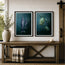 Two framed marine art prints hanging on a white shiplap wall above a rustic wooden bench. The left print shows a dark blue-grey whale print, and the right print shows green sea turtles in a deep teal underwater scene. Designed and created by HLSdesigner 