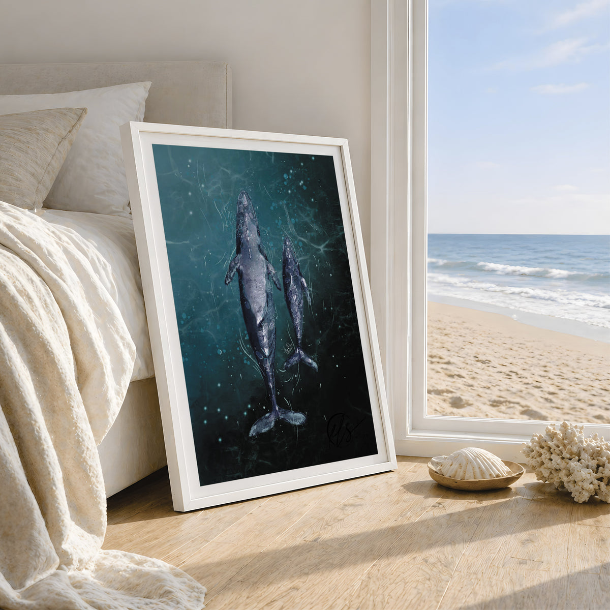 A framed art print featuring a dark blue underwater scene with two whales, leaning against a bed in a bedroom next to a window with a beach view. designed by HLSdesigner, Hannah Singleton ocean inspired fine artist and illustrator based in Cornwall