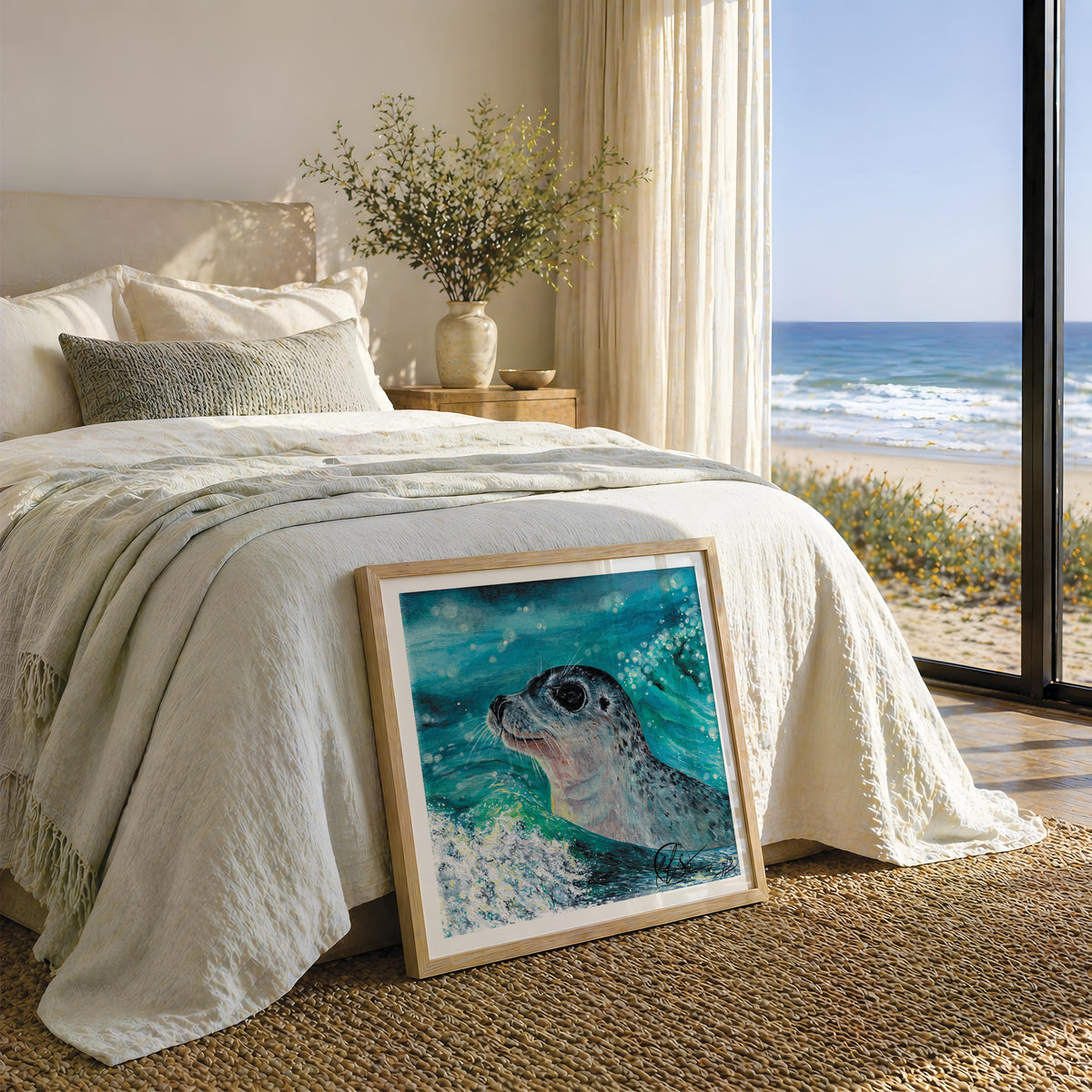 This image shows a beautiful coastal beach house or holiday home, with a placement of gentle curiosity - a little seal popping his head out of the waves in an acrylic painting as a fine art print framed against the end of the bed, while watching waves roll into the shoreline just outside the patio door. This mock up is a showcase for the print itself and does not show the print to scale, sizes are approximate and images are for representation only. Designed and made by HLSdesigner, Hannah Singleton 