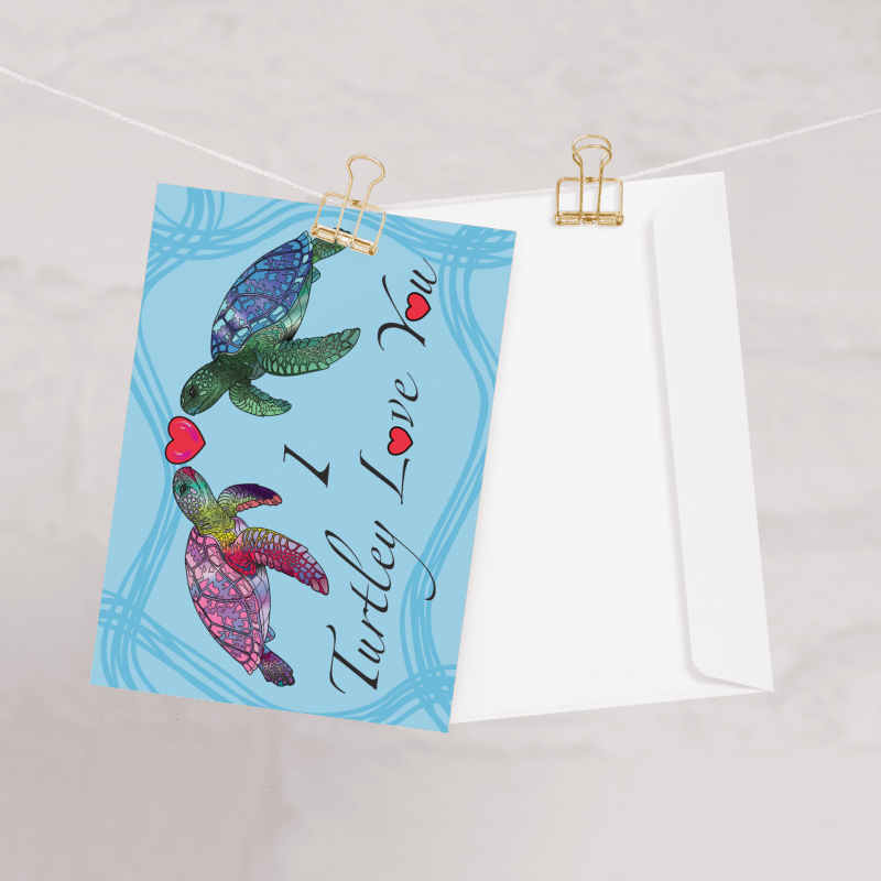 Card with turtles and 'I Turtley Love You' text on a blue background, clipped to a line.