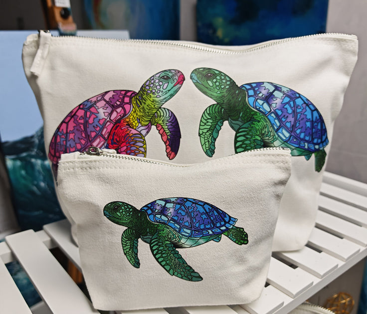 large and small cosmetic turtle bags, comparison in size. the large bag has two turtles on and the small bag has one, we also have a medium bag too with a larger single pink turtle on which is not in this image