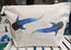 large 5 litre whale shark cosmetic bag, off white cotton canvas accessory bag with metal zip,  with ocean themed artwork in the background. whale shark illustration fading from blue to green with white spots pressed onto the bag