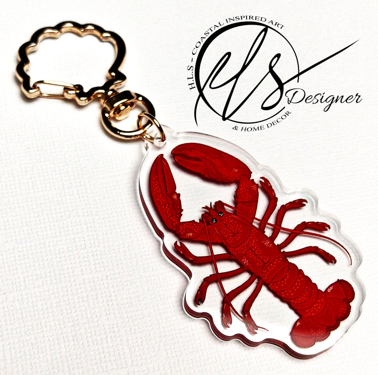 Red lobster keychain with gold ring on a white background, featuring 'HLS Designer' logo.