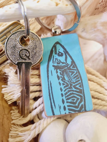 Key with a decorative fish tag on a textured surface, hand painted mackerel head keyring y HLSdesigner