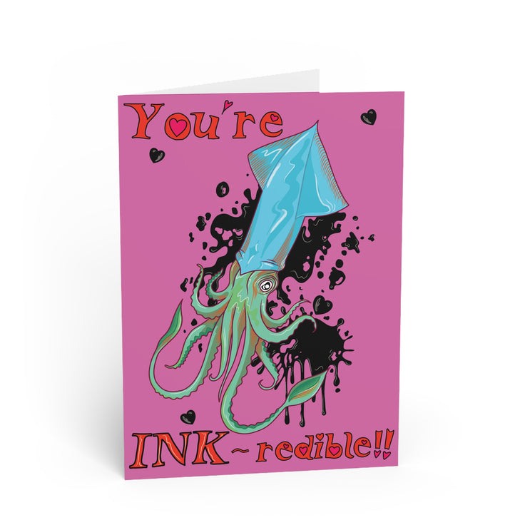 ocean pun greetings card in vivid pink with a blue and green squid with black ink forming hearts around and hand written bubble writing which reads 'you're INK-redible' designed and made by HLSdesigner