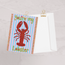 you're my lobster greetings card featuring HLSdesigner illustrations on a red and orange lobster with adorable loving eyes, green bubble text with heart centres and a blue and pale pink striped background with an orange tassel effect on each side, ocean inspired pun greetings cards designed and made by HLSdesigner