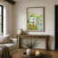 A framed watercolour painting of a coastal village and harbour of Polperro and the old watch house hangs on a white panelled wall above a rustic wooden console table in a bright, modern living room. Originally painted in watercolour by Robert Singleton, his use of colour washes creates a contemporary feel with abstract form. Reproduced lovingly by his daughter Hannah at HLSdesigner