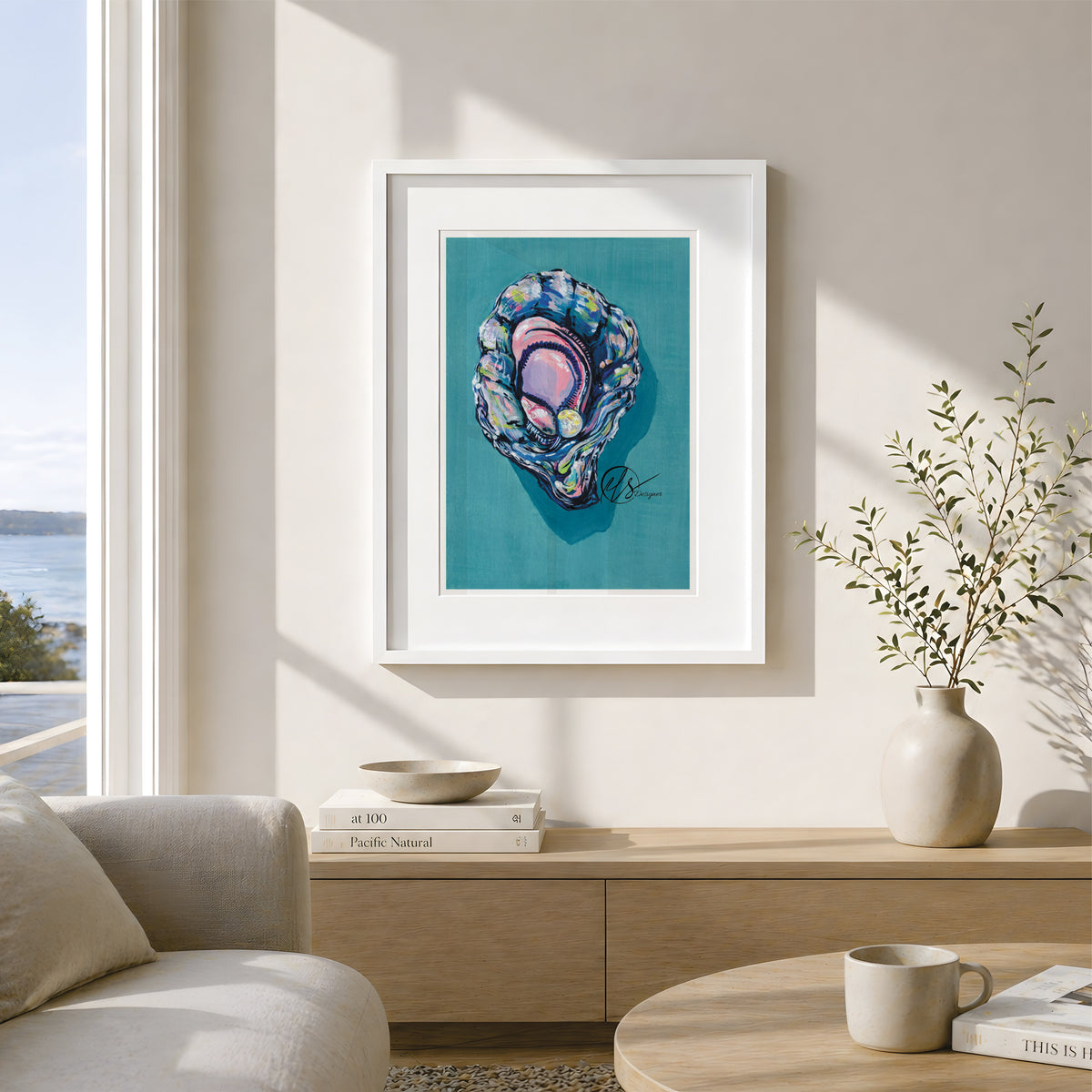 A framed art print featuring a colorful abalone shell illustration on a teal background, displayed on a beige wall in a modern, sunlit living room setting. This is a gouache painting to represent a colourful and vibrant king oyster featuring Lemon yellow hues paired lovingly with oyster blue and lilac shading to create a 3d effect. Painted and reproduced into prints by artist Hannah Singleton, ocean inspired illustrator and seafood artist from cornwall at HLSdesigner