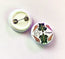 Button badge with turtle design and HLS 'Designer' text on a white background with turtles and shells, handmade and designed in house