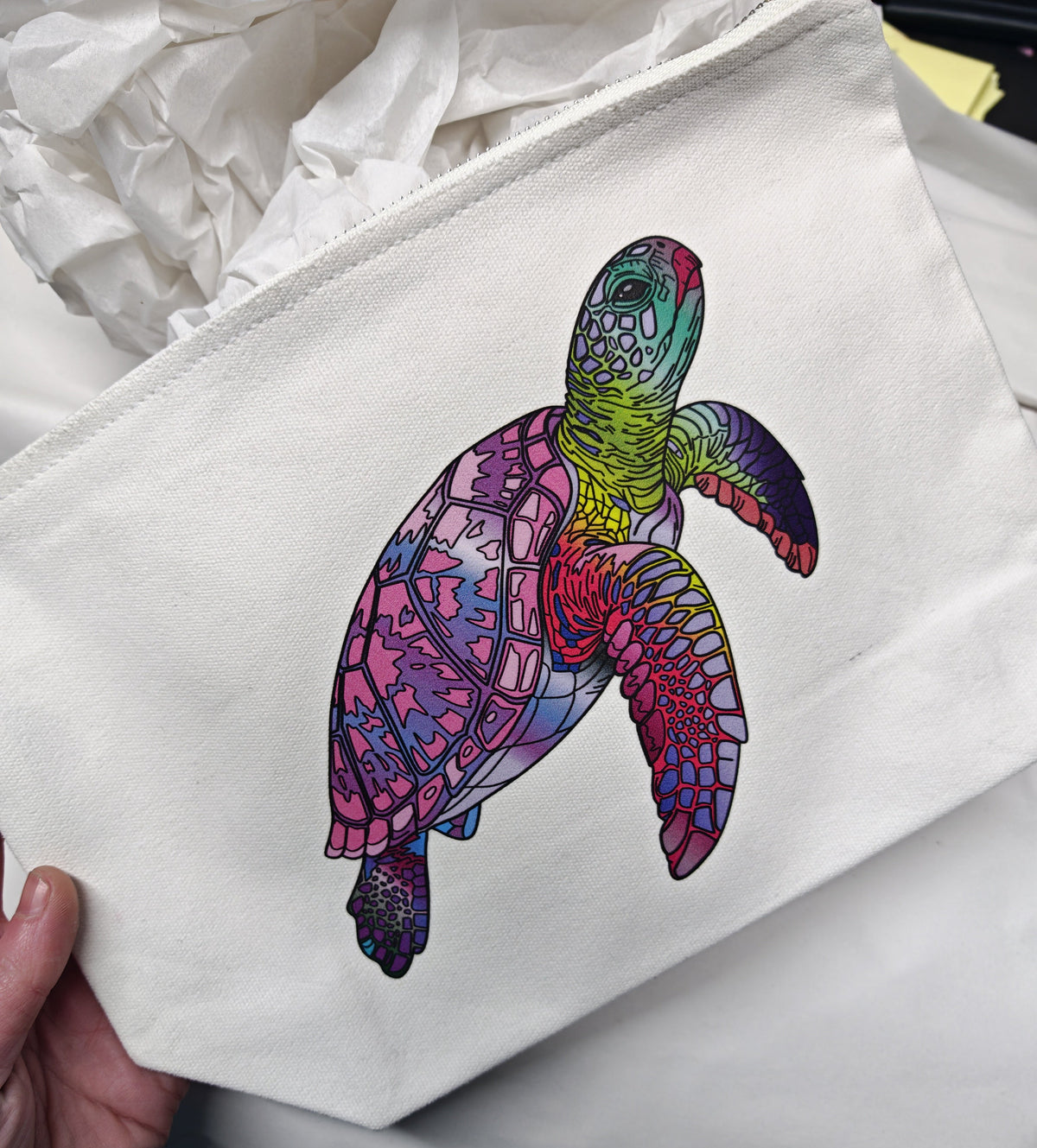cosmetic bag flat lay design printed onto an off white cosmetic bag in medium size with tissue background, here i am holding the bag to compare the size for the viewer 