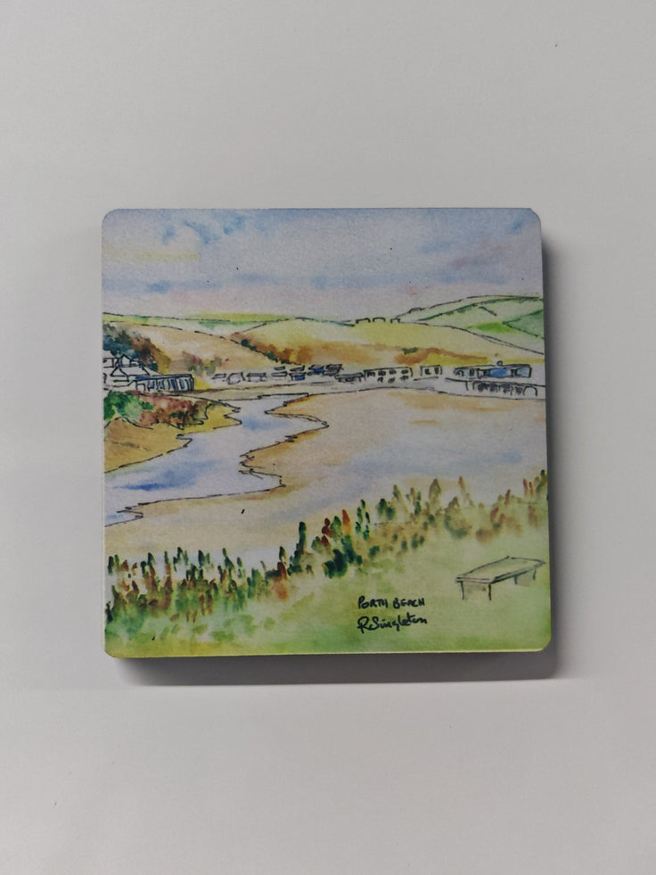a square wooden fridge magnet with a printed watercolour painting of Porth beach in Newquay Cornwall. painted using colour washes and use of negative space by R Singleton - tribute collection reproduced exclusively by HLSdesigner, showing the beach from the higher footpath where a bench lies vacant to take in the views of the rolling in stream and the camp site behind. 