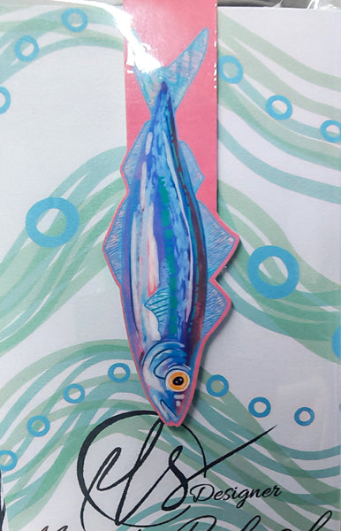 sardine illustration handmade magnetic bookmark on a pink background, cardstock and magnets encase the page holding the place of reading. on a seaweed inspired swirled backing card