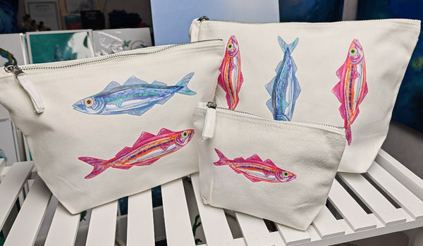 set of three sardine cosmetic bag printed onto an off white brushed cotton canvas bag with silver zip, this features a sardines illustration by hlsdesigner and is pressed in house.