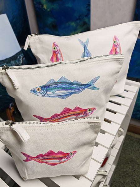 set of three sardine cosmetic bags printed onto an off white brushed cotton canvas bag with silver zip, this features a pink and orange sardine illustration by hlsdesigner and is pressed in house.