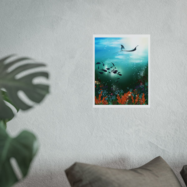 Unframed artwork of an underwater scene with fish and a shark on a white wall.Underwater scene with fish and a manta ray, surrounded by plants and flowers. unframed art print, ray swimming above shoals of fish gathering in a underwater void with laying corals on a reef below the ocean surface. illustration designed by hlsdesigner digitally