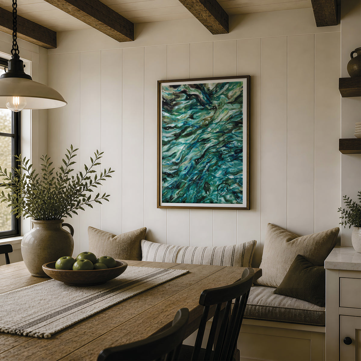 A framed abstract painting with swirling teal, blue, and green brushstrokes hangs on a white panelled wall in a rustic dining room setting with a wooden table, bench, and hanging lamp. Swirling shallows. Fine art print featuring teal greens of shading and blending techniques to form a contemporary and modern abstract art piece that looks stunning in any space. Close up ocean viewpoints inspire Hannah Singleton in her artwork, designed and reproduced by Hannah at HLSdesigner