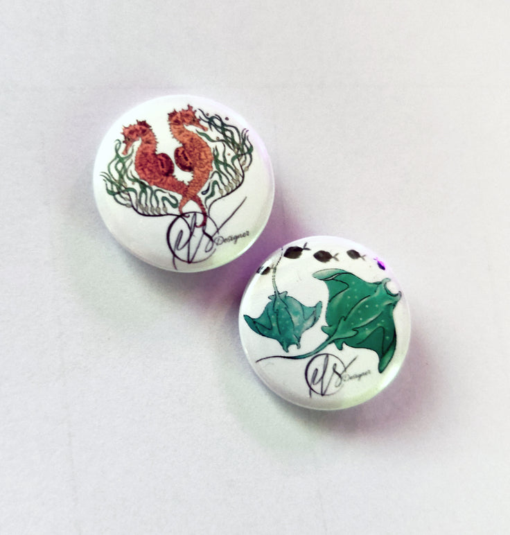 two handmade pin badges with seahorses from the seahorse trident series and two manta rays on the badge available in a set of two. handmade and designed by HLSdesigner