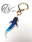 Blue and white with a green hue whale shark-shaped acrylic keychain with gold seashell clasp ring on a white background, featuring 'HLS Designer' logo.